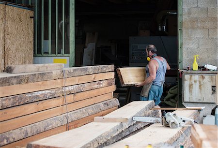 stacking wood - Carpenter working in workshop Stock Photo - Premium Royalty-Free, Code: 649-08744876