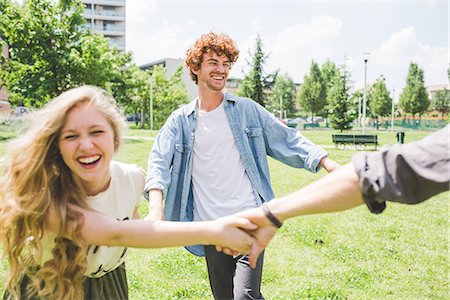 shirt closeup - Friends circle dancing in park Stock Photo - Premium Royalty-Free, Code: 649-08745036