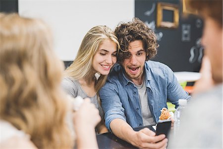 simsearch:614-06442908,k - Co-workers having morning break at table Stock Photo - Premium Royalty-Free, Code: 649-08745058