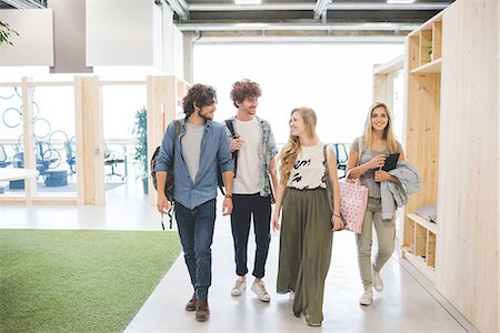 simsearch:649-08745093,k - Co-workers walking along corridor in open plan office Foto de stock - Royalty Free Premium, Número: 649-08745072