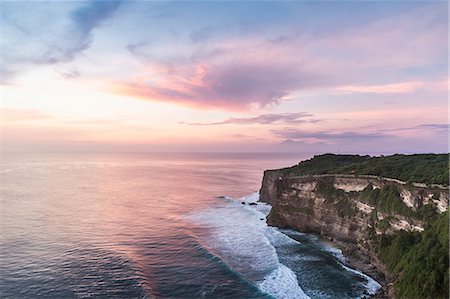 Elevated view of cliffs and sea at sunset, Uluwatu, Bali, Indonesia Stock Photo - Premium Royalty-Free, Code: 649-08745130