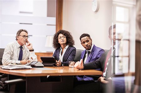 simsearch:649-08745576,k - Business team listening at boardroom table Photographie de stock - Premium Libres de Droits, Code: 649-08745345