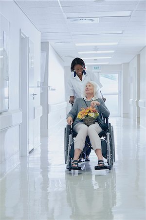 dependence - Hospital orderly pushing senior female patient in wheelchair Stock Photo - Premium Royalty-Free, Code: 649-08745395