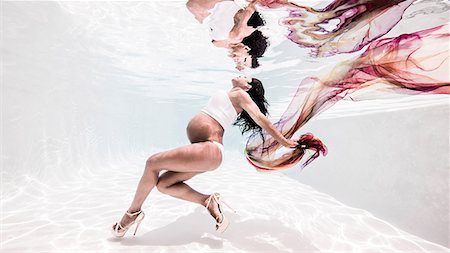 female underwater still - Underwater view of pregnant woman, face towards surface of water Stock Photo - Premium Royalty-Free, Code: 649-08745471
