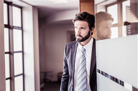 simsearch:649-07119762,k - Confident businessman waiting at office doorway Stock Photo - Premium Royalty-Free, Code: 649-08745574