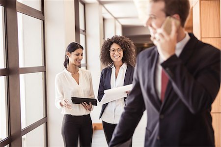 simsearch:649-08924437,k - Young businesswomen and businessman in office corridor Stock Photo - Premium Royalty-Free, Code: 649-08745602