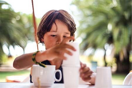 Boy balancing plastic cups Stock Photo - Premium Royalty-Free, Code: 649-08745695