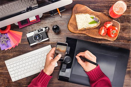 sandwich top view - Overhead view of male hands editing photographs from smartphone on  graphic design tablet using digital pen Stock Photo - Premium Royalty-Free, Code: 649-08745744