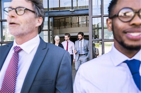 simsearch:649-06844806,k - Close up of businessmen leaving office building Fotografie stock - Premium Royalty-Free, Codice: 649-08765800