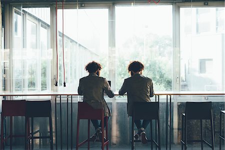 fraternal twin brothers - Rear view of male hipster twins working at office desk Stock Photo - Premium Royalty-Free, Code: 649-08765954