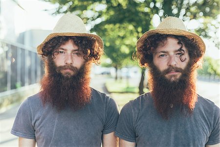 fraternal twins - Portrait of identical male hipster twins wearing straw hats on sidewalk Stock Photo - Premium Royalty-Free, Code: 649-08765961