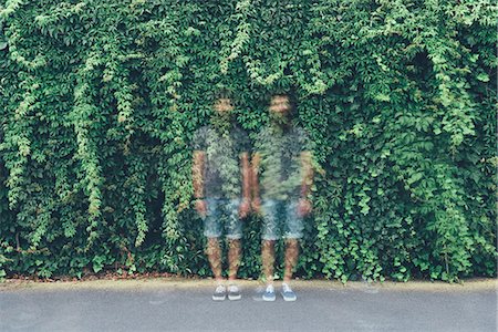 Double exposure portrait of transparent identical adult male twins and green foliage Stock Photo - Premium Royalty-Free, Code: 649-08765971