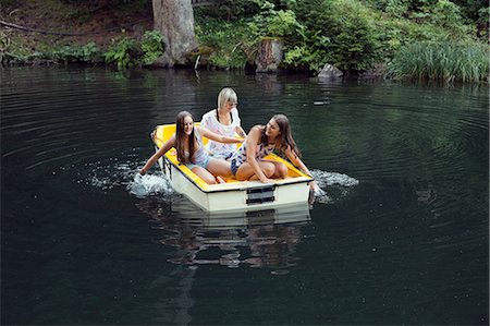 simsearch:649-08824522,k - Three adult female friends hand paddling rowing boat on lake, Sattelbergalm, Tirol, Austria Stock Photo - Premium Royalty-Free, Code: 649-08766004