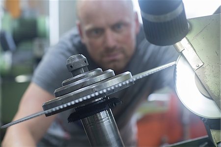 Man checking rotary blade on grinding machine Stock Photo - Premium Royalty-Free, Code: 649-08766120