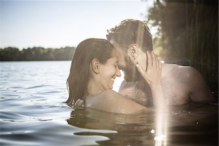 simsearch:649-08543868,k - Couple face to face hugging, smiling in water, Berlin, Germany Stock Photo - Premium Royalty-Free, Code: 649-08766196