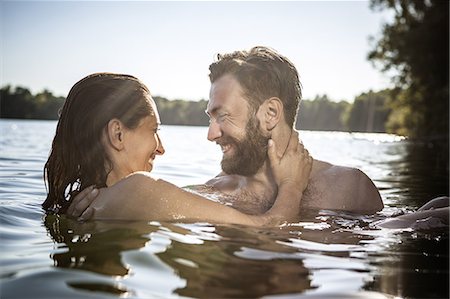 simsearch:649-08543868,k - Couple face to face hugging, smiling in water, Berlin, Germany Stock Photo - Premium Royalty-Free, Code: 649-08766197