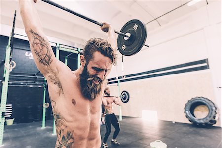 sports training - Young male cross trainer snatch lifting barbell in gym Stock Photo - Premium Royalty-Free, Code: 649-08766477