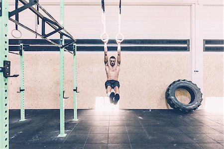 simsearch:649-08766485,k - Young male cross trainer training on gymnastic rings Stock Photo - Premium Royalty-Free, Code: 649-08766470