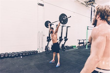 simsearch:649-08766481,k - Young male cross trainer snatch lifting barbell in gym Stock Photo - Premium Royalty-Free, Code: 649-08766481