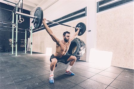 fitness men - Young man weightlifting barbell in cross training gym Stock Photo - Premium Royalty-Free, Code: 649-08766537