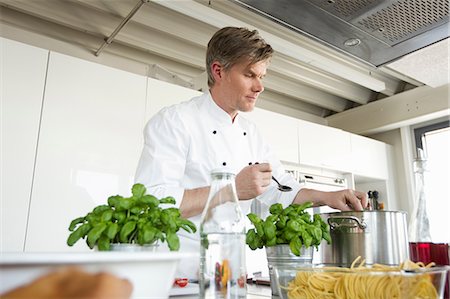 simsearch:614-08885076,k - Chef in commercial kitchen cooking Stock Photo - Premium Royalty-Free, Code: 649-08824320