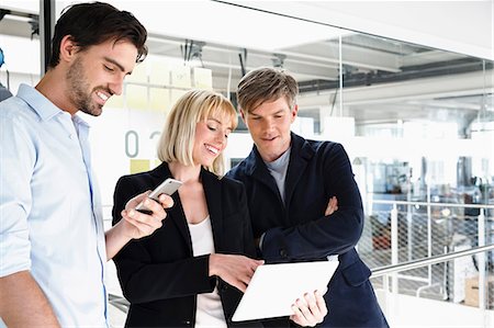 simsearch:649-08824281,k - Business people in office looking at digital tablet Stock Photo - Premium Royalty-Free, Code: 649-08824338