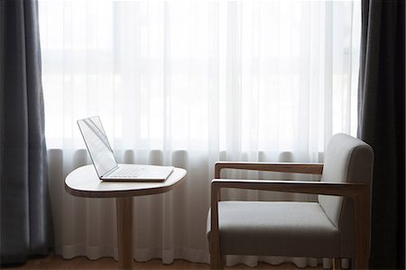Laptop on desk with chair, in front of window Stock Photo - Premium Royalty-Free, Code: 649-08824378