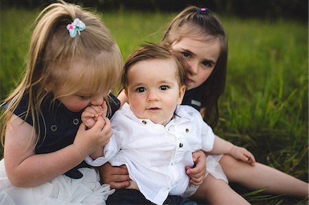 sister hugs baby - Sisters hugging baby brother Stock Photo - Premium Royalty-Free, Code: 649-08824442