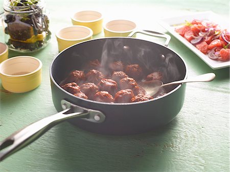 Saucepan of steaming greek meatballs on table Stock Photo - Premium Royalty-Free, Code: 649-08824496