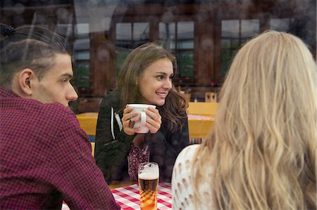 simsearch:649-08824511,k - Three young adult friends with herbal tea and beer in cafée Stock Photo - Premium Royalty-Free, Code: 649-08824510