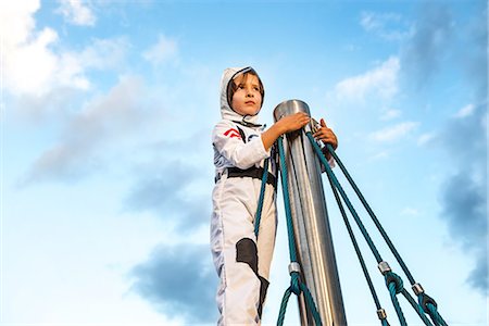 simsearch:649-09139265,k - Boy in astronaut costume looking out from top of climbing frame Stock Photo - Premium Royalty-Free, Code: 649-08824614