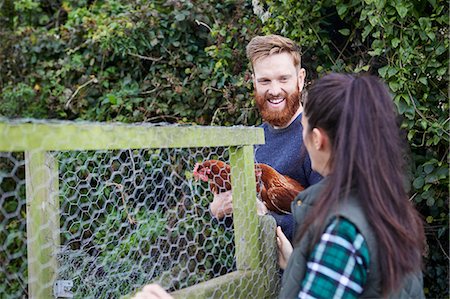 simsearch:649-08824789,k - Young couple on chicken farm holding chickens Photographie de stock - Premium Libres de Droits, Code: 649-08824745