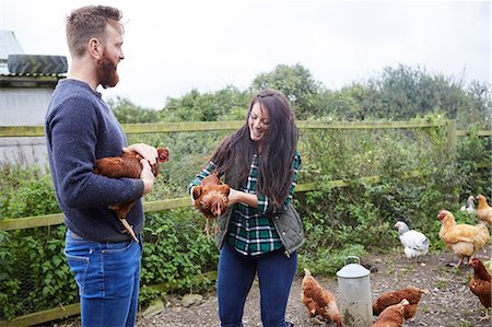 simsearch:614-08877761,k - Young couple on chicken farm holding chickens Stock Photo - Premium Royalty-Free, Code: 649-08824741