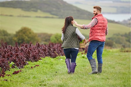 Rear view of couple on farm harvesting lettuce Stock Photo - Premium Royalty-Free, Code: 649-08824761