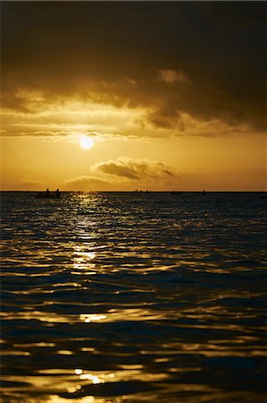 simsearch:649-08824843,k - Silhouette of people in boats boats on sea at sunrise, Tenby, Pembrokeshire, Wales Stock Photo - Premium Royalty-Free, Code: 649-08824844