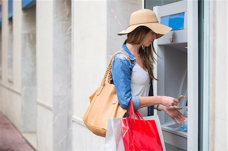 Woman withdrawing cash from cash machine Stock Photo - Premium Royalty-Free, Code: 649-08824873