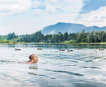 swimming girls in water - Girl swimming in lake, Fuessen, Bavaria, Germany Stock Photo - Premium Royalty-Free, Code: 649-08824931