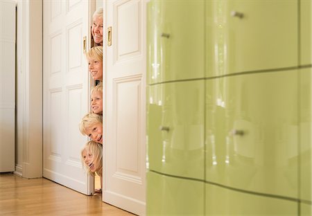 simsearch:614-07032044,k - Grandmother and grandsons poking head through doorway Stock Photo - Premium Royalty-Free, Code: 649-08824957