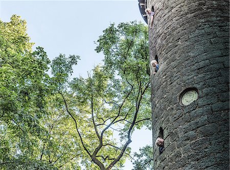 simsearch:400-06794010,k - Boys leaning out of stone tower windows Stock Photo - Premium Royalty-Free, Code: 649-08824964