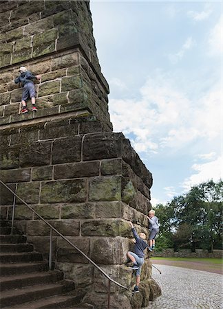 simsearch:400-06794010,k - Boys climbing stone wall Stock Photo - Premium Royalty-Free, Code: 649-08824967
