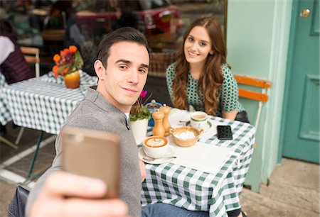 date pride - Couple at pavement cafée talking selfie Stock Photo - Premium Royalty-Free, Code: 649-08825046