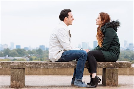 simsearch:649-08306717,k - Side view of couple sitting face to face on bench Photographie de stock - Premium Libres de Droits, Code: 649-08825061