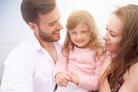 simsearch:614-09211363,k - Happy parents carrying daughter in arms Stock Photo - Premium Royalty-Free, Code: 649-08825070
