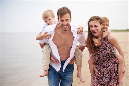simsearch:614-07031191,k - Parents giving children piggybacks on beach Stock Photo - Premium Royalty-Free, Code: 649-08825086