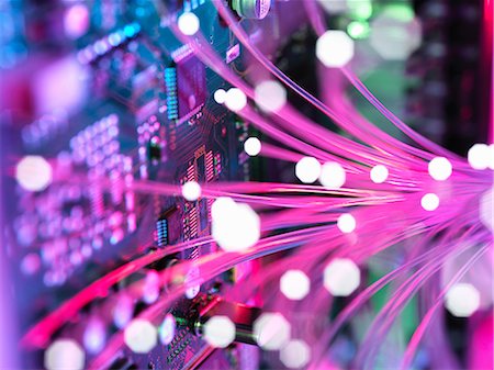 Cyber attack with fibre optics shooting past electronics of broadband hub Stock Photo - Premium Royalty-Free, Code: 649-08825207