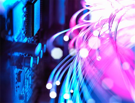 Cyber attack with fibre optics shooting past electronics of broadband hub Stock Photo - Premium Royalty-Free, Code: 649-08825208