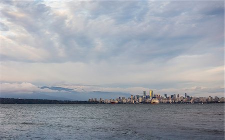 Distant view of city skyline over Vancouver harbour, Vancouver, Canada Stock Photo - Premium Royalty-Free, Code: 649-08825216