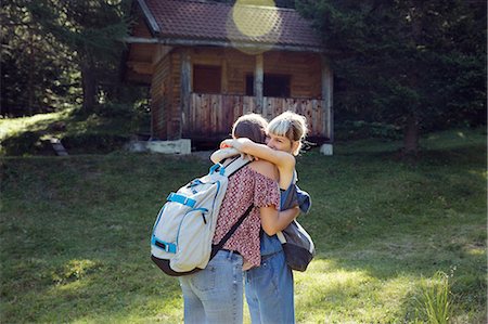 simsearch:649-08824142,k - Two female friends hugging in forest glade, Sattelbergalm, Tyrol, Austria Fotografie stock - Premium Royalty-Free, Codice: 649-08825242