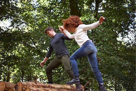 simsearch:649-07281037,k - Couple in forest holding hands balancing on fallen tree Stock Photo - Premium Royalty-Free, Code: 649-08825293