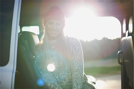 Sunlit portrait of young woman sitting in back of car Stock Photo - Premium Royalty-Free, Code: 649-08839956
